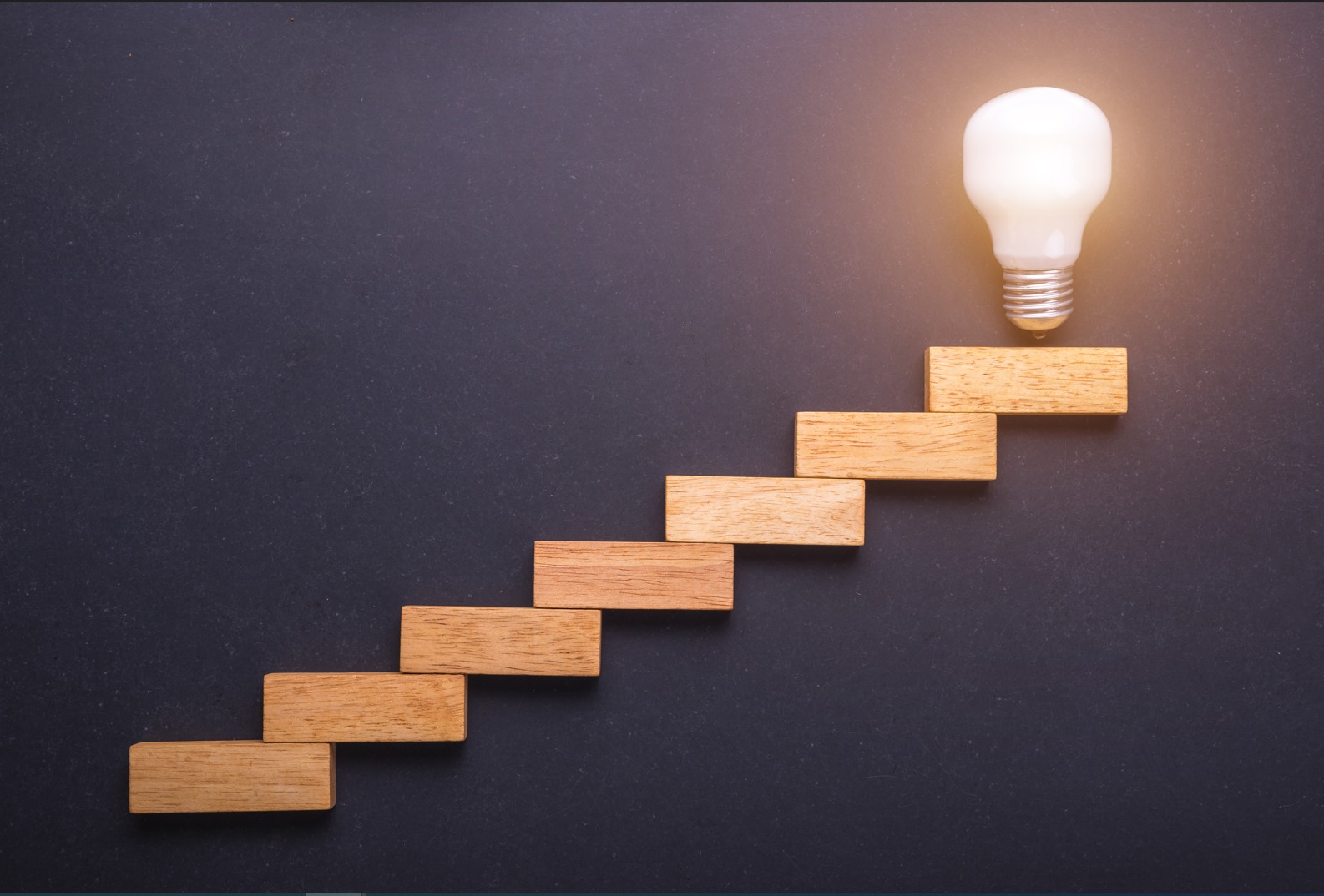 stair case leading up to a light bulb